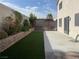 The backyard features lush artificial grass, a patio, and a landscaped perimeter at 6043 Cape Clairmont Ct, North Las Vegas, NV 89031