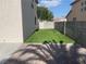 A spacious backyard features artificial turf, a concrete patio, and block wall fences at 6043 Cape Clairmont Ct, North Las Vegas, NV 89031