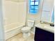 Bathroom with a granite vanity, sink, toilet, bathtub and tile flooring at 6043 Cape Clairmont Ct, North Las Vegas, NV 89031