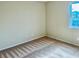 A simple bedroom design with clean walls, neutral carpet, and a window providing natural light at 6043 Cape Clairmont Ct, North Las Vegas, NV 89031