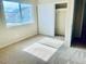 Bedroom featuring carpeted floor, window with view, and closet with sliding doors at 6043 Cape Clairmont Ct, North Las Vegas, NV 89031