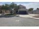 Inviting home featuring a two-car garage, low-maintenance landscaping, and a spacious driveway for additional parking at 6043 Cape Clairmont Ct, North Las Vegas, NV 89031