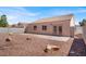 A sunny backyard with rock landscaping, a covered patio, and a view of the home at 612 Moontide Ct, Henderson, NV 89011