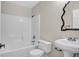 Bright bathroom with a tiled shower/tub combo and a vanity with an ornate mirror at 612 Moontide Ct, Henderson, NV 89011