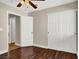 A cozy bedroom featuring wood floors, a ceiling fan, and a closet with sliding doors at 612 Moontide Ct, Henderson, NV 89011