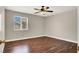 Comfortable bedroom with hardwood floors, a ceiling fan, and natural light from the window at 612 Moontide Ct, Henderson, NV 89011