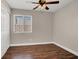 Comfortable bedroom with hardwood floors, a ceiling fan, and a window at 612 Moontide Ct, Henderson, NV 89011