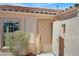 Inviting entryway featuring a beige front door, textured walls, and a decorative outdoor light fixture at 612 Moontide Ct, Henderson, NV 89011