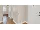 Bright hallway showcasing tiled floors, white trim, and access to multiple rooms in the home at 612 Moontide Ct, Henderson, NV 89011