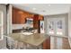 Updated kitchen featuring stainless steel appliances, stone countertops, and a view of the outdoor patio at 612 Moontide Ct, Henderson, NV 89011