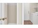 A well-lit laundry area with a washer, dryer, and convenient closet shelving at 612 Moontide Ct, Henderson, NV 89011