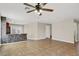 Spacious living room with tile floors, ceiling fan, and a decorative kitchen island for casual dining at 612 Moontide Ct, Henderson, NV 89011