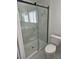This modern bathroom features a glass shower with marble walls and a toilet at 6402 Agua Dr, Las Vegas, NV 89103