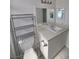 Bathroom with white vanity, tile flooring, and a bright mirror at 6402 Agua Dr, Las Vegas, NV 89103