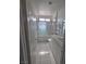 Clean bathroom featuring tiled shower, white vanity and ample lighting at 6402 Agua Dr, Las Vegas, NV 89103