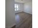 Bedroom featuring wood-look flooring and natural light from the window at 6402 Agua Dr, Las Vegas, NV 89103