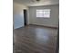 This bedroom features wood floors and a window for natural light at 6402 Agua Dr, Las Vegas, NV 89103