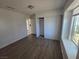 Bedroom with wood floors, sliding closet doors, and natural light at 6402 Agua Dr, Las Vegas, NV 89103