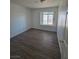 This bedroom features wood floors and a window for natural light at 6402 Agua Dr, Las Vegas, NV 89103