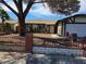 Single-story home with desert landscaping, wrought iron fence and a two-car garage, offering curb appeal and convenience at 6402 Agua Dr, Las Vegas, NV 89103