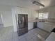 Bright kitchen with stainless steel refrigerator, sleek countertops, and ample cabinet space, ideal for modern living at 6402 Agua Dr, Las Vegas, NV 89103