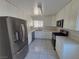 Well-lit kitchen featuring stainless steel appliances, modern cabinetry, and tile flooring, offering both style and functionality at 6402 Agua Dr, Las Vegas, NV 89103