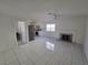 Bright living room showcases a fireplace, tile floors, and access to the kitchen area at 6402 Agua Dr, Las Vegas, NV 89103