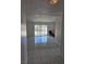 Living room featuring tile floors, neutral paint, and access to the backyard at 6402 Agua Dr, Las Vegas, NV 89103