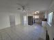 Open concept living room featuring tile floors, ceiling fan, and an adjacent kitchen at 6402 Agua Dr, Las Vegas, NV 89103