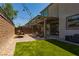 Backyard featuring artificial grass, a paver patio with a pergola, and string lights at 6927 Desert Finch St, North Las Vegas, NV 89084