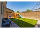 Backyard with a playset and artificial grass at 6927 Desert Finch St, North Las Vegas, NV 89084