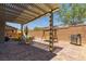 Backyard featuring a patio, pergola, dining area, and a swing with artificial grass at 6927 Desert Finch St, North Las Vegas, NV 89084