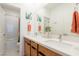 Bright bathroom with double sinks, white countertops, and decorative accents at 6927 Desert Finch St, North Las Vegas, NV 89084
