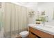 Cozy bathroom features a shower with curtain, and a clean countertop at 6927 Desert Finch St, North Las Vegas, NV 89084