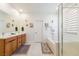Bright bathroom with double sinks, soaking tub, and glass-enclosed shower at 6927 Desert Finch St, North Las Vegas, NV 89084