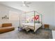 Bright bedroom with four-poster bed, large windows, and neutral decor at 6927 Desert Finch St, North Las Vegas, NV 89084
