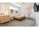 Cozy bedroom with natural light, soft carpet, and a neutral color palette at 6927 Desert Finch St, North Las Vegas, NV 89084