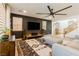 Modern living room with a large flat-screen TV, comfortable seating, and stylish decor at 6927 Desert Finch St, North Las Vegas, NV 89084