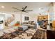 Open-concept living room with hardwood floors, a modern sofa, and access to the kitchen at 6927 Desert Finch St, North Las Vegas, NV 89084