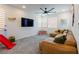 Spacious living room with a sectional sofa, large TV, and playful decor at 6927 Desert Finch St, North Las Vegas, NV 89084