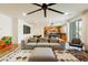 Bright living space with a large sofa, modern decor, and an open flow to the kitchen and outdoor area at 6927 Desert Finch St, North Las Vegas, NV 89084