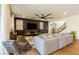 Spacious living room features a large ceiling fan, a stylish rug, and a comfortable gray sofa at 6927 Desert Finch St, North Las Vegas, NV 89084
