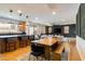 Open-concept living space featuring a kitchen island, dining area, and living room with modern decor at 6927 Desert Finch St, North Las Vegas, NV 89084