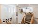 View of the loft featuring neutral walls, carpeted stairs, wood railing, and a comfortable seating area at 6927 Desert Finch St, North Las Vegas, NV 89084