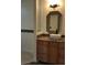 Stylish bathroom featuring a modern vanity, vessel sink, decorative mirror, and mosaic tile accents at 728 Apple Tree Ct, Henderson, NV 89014