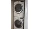 Efficient laundry area with stacked washer and dryer, and bright lighting at 728 Apple Tree Ct, Henderson, NV 89014
