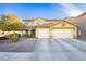Charming two-story home with a three-car garage and a well-manicured front yard with mature landscaping at 7317 Wild Roar Ave, Las Vegas, NV 89129