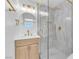 This bathroom boasts stylish light gray wall tiles, a luxurious glass-enclosed shower, and elegant gold fixtures at 747 Greenbriar Townhouse Way, Las Vegas, NV 89121