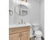 Modern powder room featuring a round mirror, stylish vanity, and elegant fixtures at 747 Greenbriar Townhouse Way, Las Vegas, NV 89121
