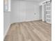 Bright bedroom showcases wood-look floors and a sleek closet with sliding barn door, enhancing space at 747 Greenbriar Townhouse Way, Las Vegas, NV 89121